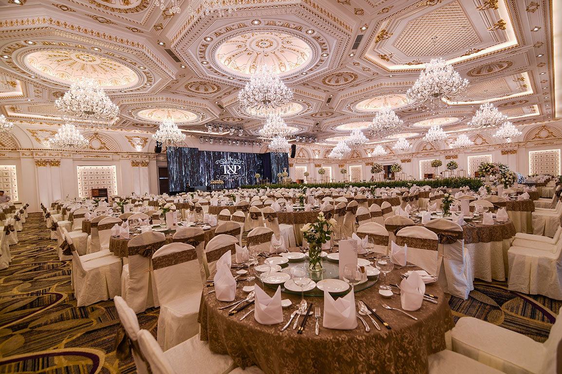 The Mira Central Park grand ballroom — gold-coffered domed ceiling with crystal chandeliers and full banquet seating